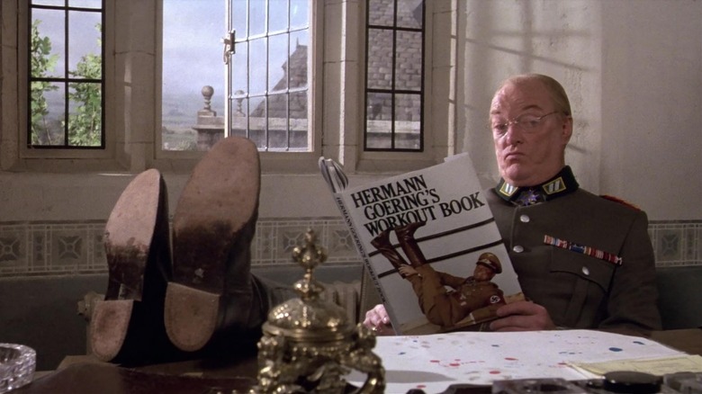 Jeremy Kemp as Gen. Streck does some reading in Top Secret!