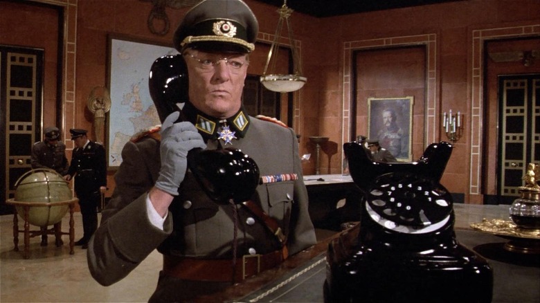 Jeremy Kemp as Gen. Streck answers the phone in "Top Secret!"