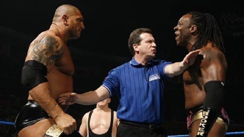 A ref separates Batista and Booker T