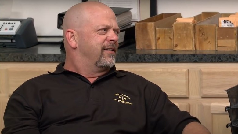 Rick Harrison frowning and sitting