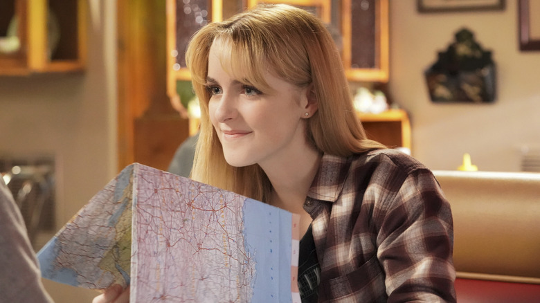 Paige holding map smiling