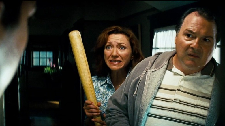 Sam's parents holding bat