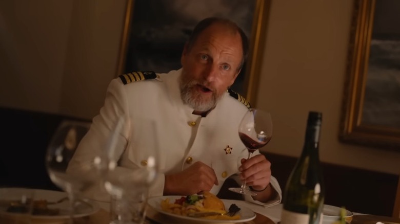 The Captain holding wine glass