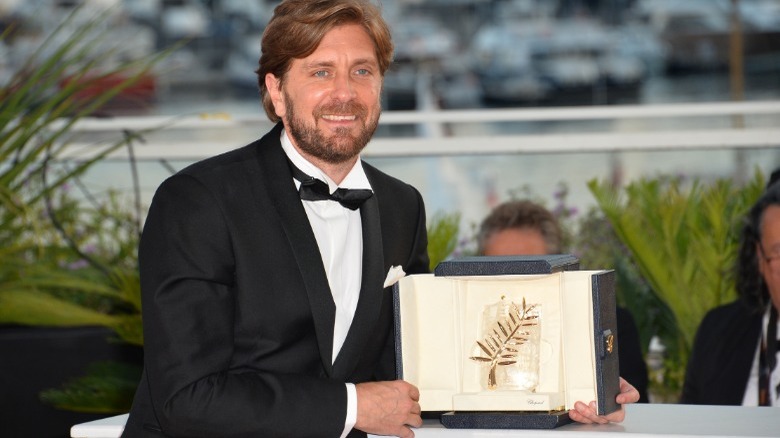 Ruben Ostlund holding Palme d'Or award