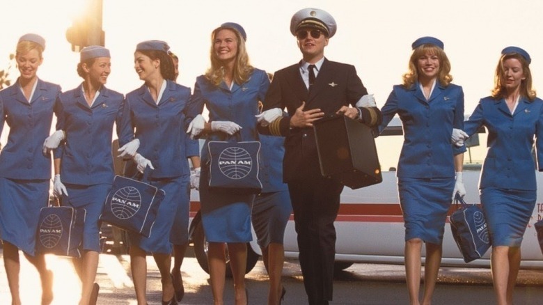 Frank walking with flight attendants