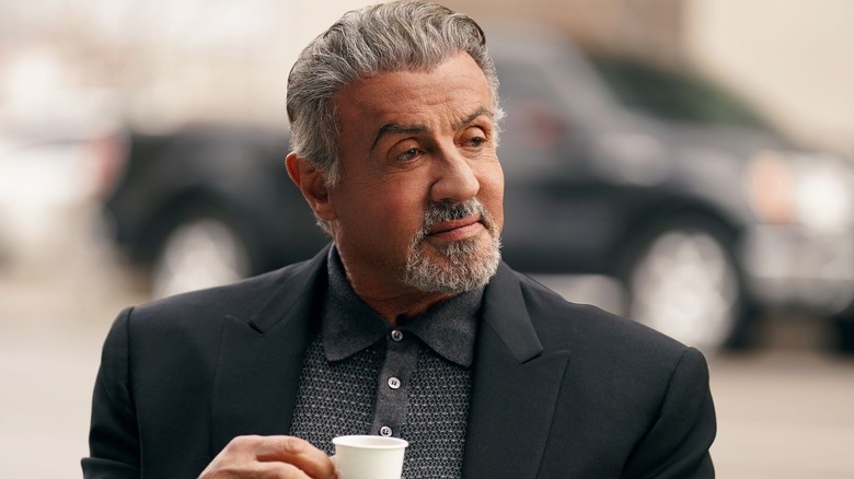 Stallone holding a coffee