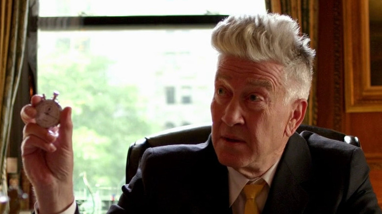 Louie David Lynch holds up a stopwatch