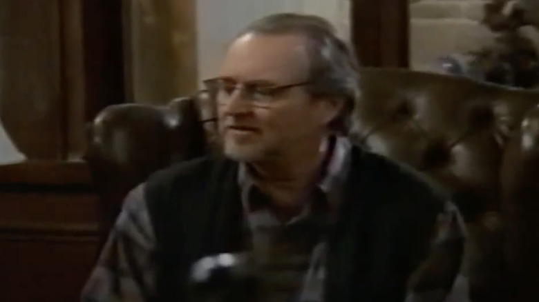 Stark Raving Mad Wes Craven sits in a brown chair