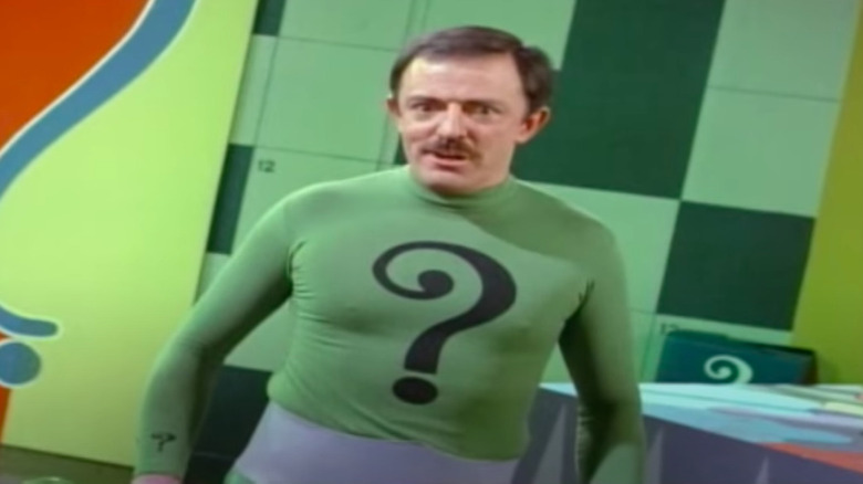 John Astin with question mark on shirt