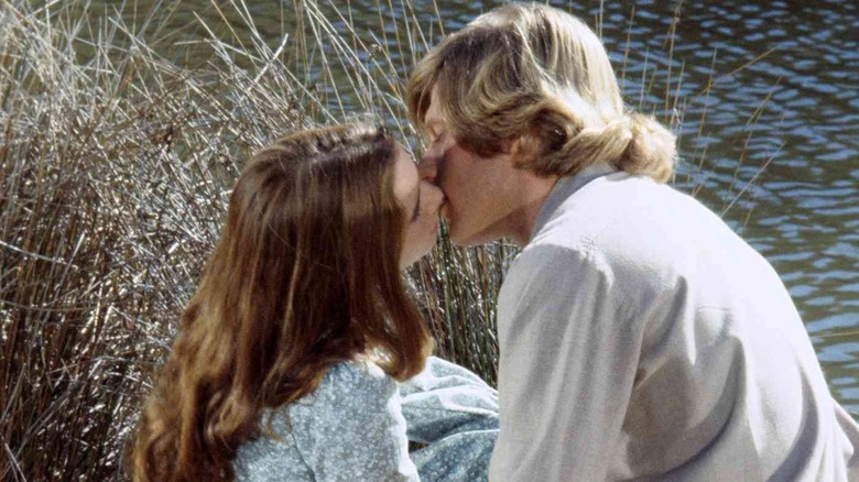 Laura kissing Almanzo by a lake