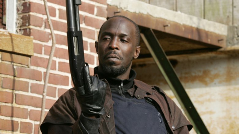 Michael K. Williams as Omar looking at his shotgun