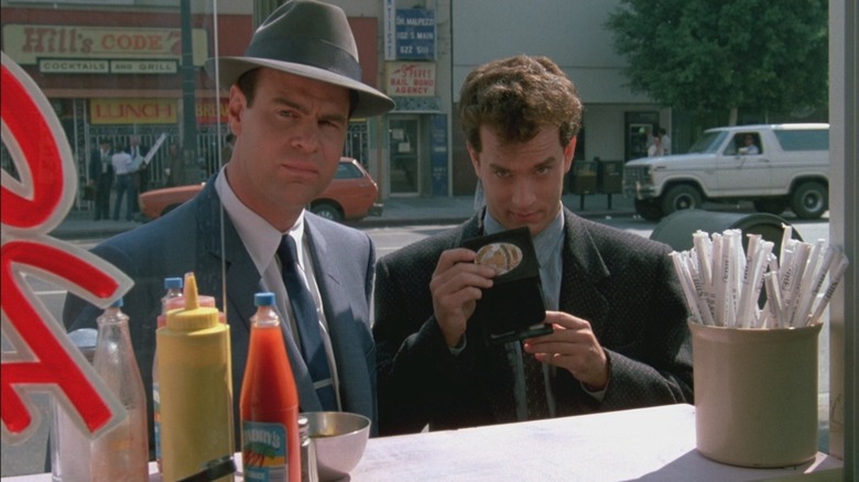 Joe and Pep show their badges at a street vendor