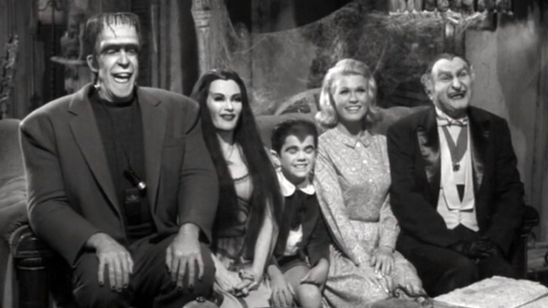 The Munsters sit on the couch
