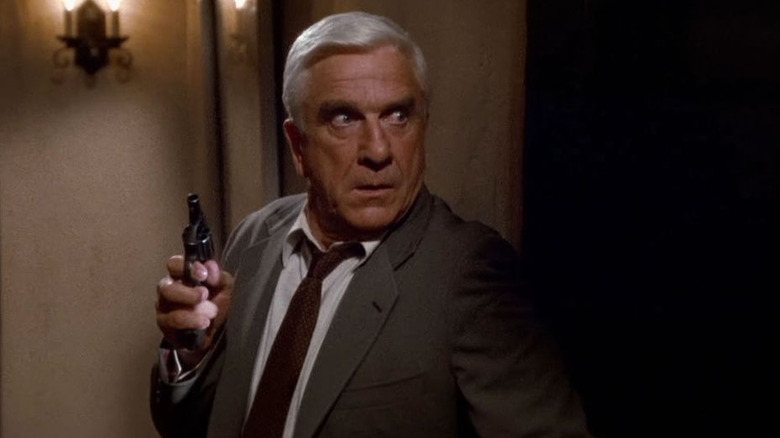 Det. Drebin hides around a corner