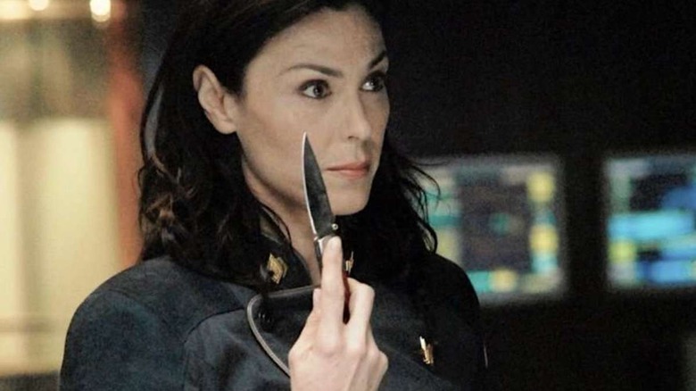 Admiral Cain holds a knife