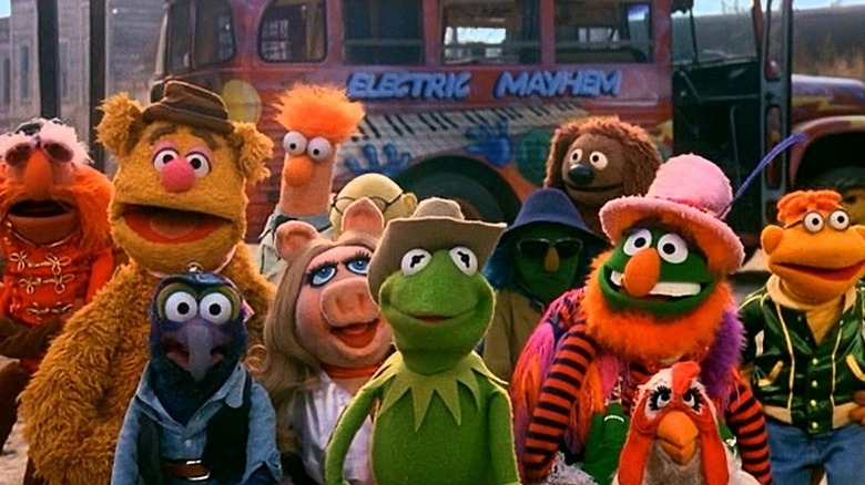 The Muppets in front of a bus