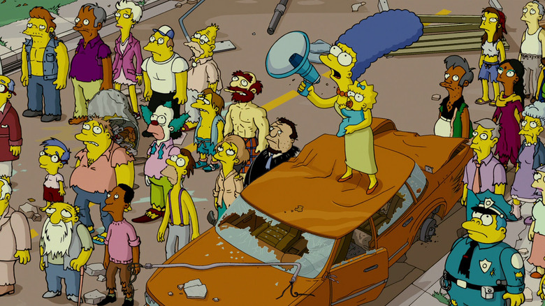 Marge on top of a car with a bullhorn