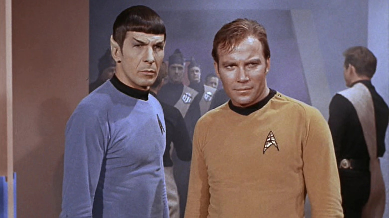 Kirk and Spock stand in hallway on the Enterprise