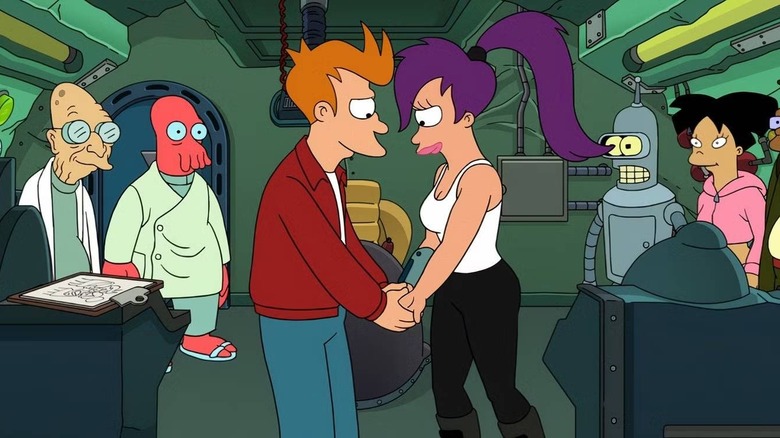 Fry and Leela holding hands amidst Planet Express crew