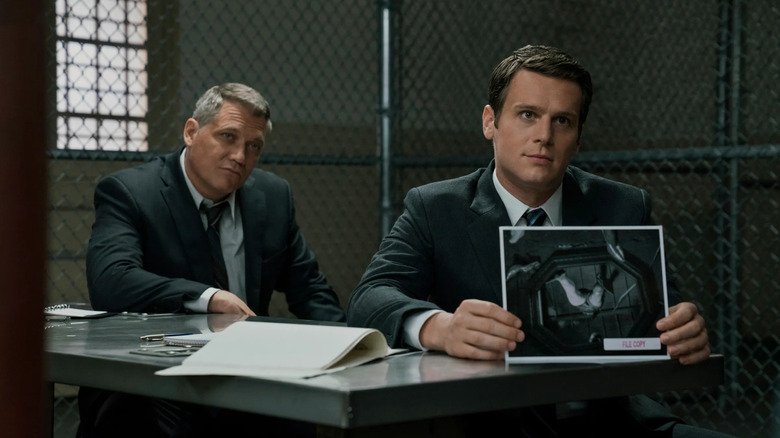 Ford and Tench show crime scene photos on "Mindhunter" (2017-2019)