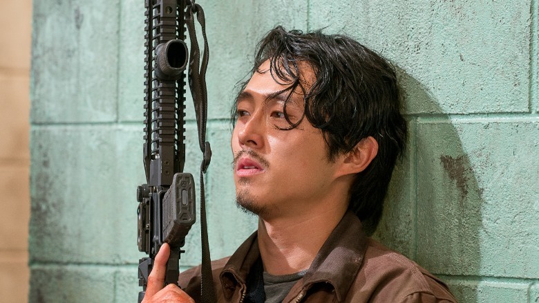 Glenn holding a gun