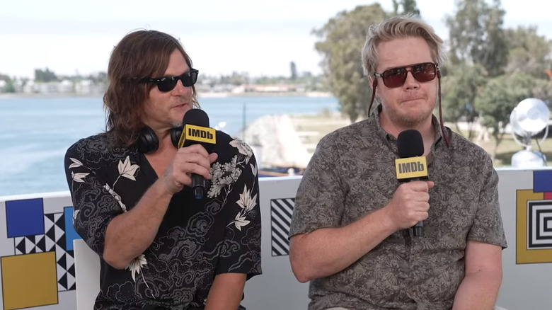 Norman Reedus and Josh McDermitt holding microphones