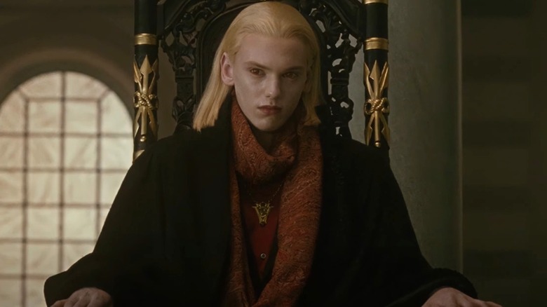 Caius looking serious while sitting in a chair