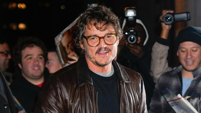 Pedro Pascal on red carpet with glasses smiling