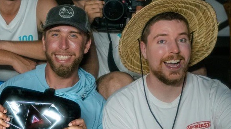 Tyler Conklin and MrBeast sitting together smiling