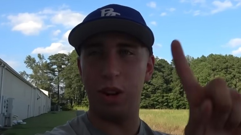 Tyler Conklin standing outside holding up a finger