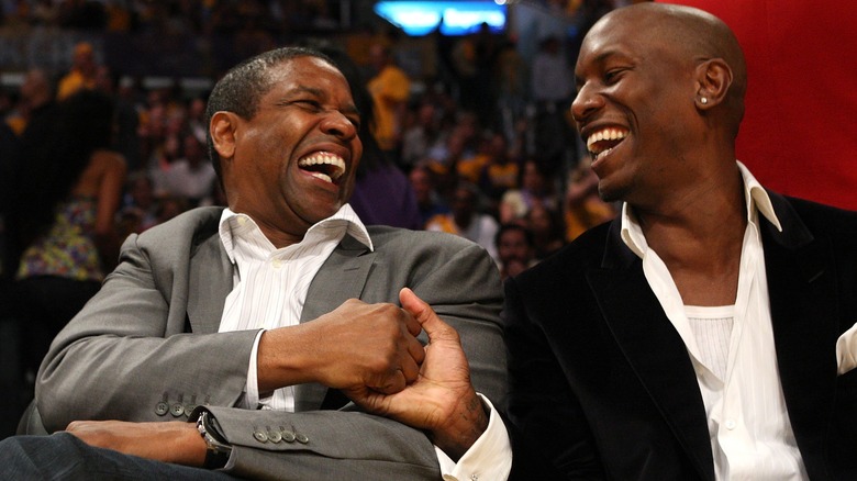 Denzel Washington and Tyrese Gibson sitting courtside 