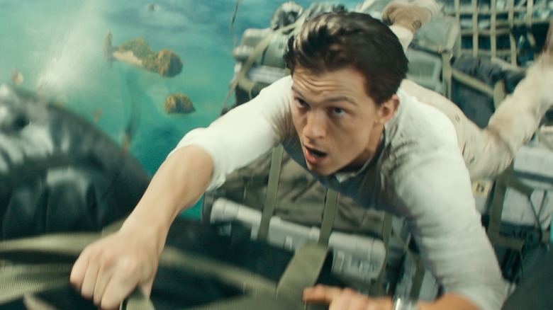 Holland holds on during an action scene in Uncharted