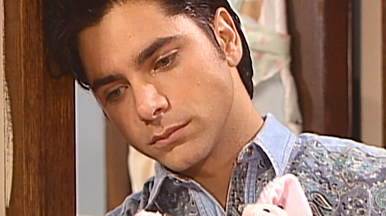 Uncle Jesse sadly holds pig