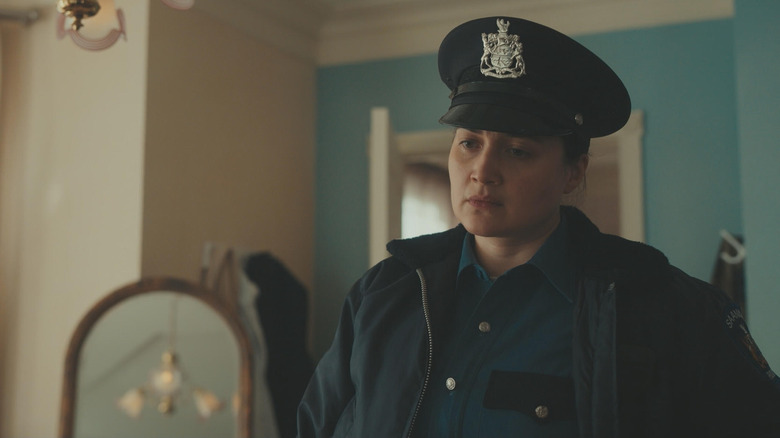 Lily Gladstone as police officer