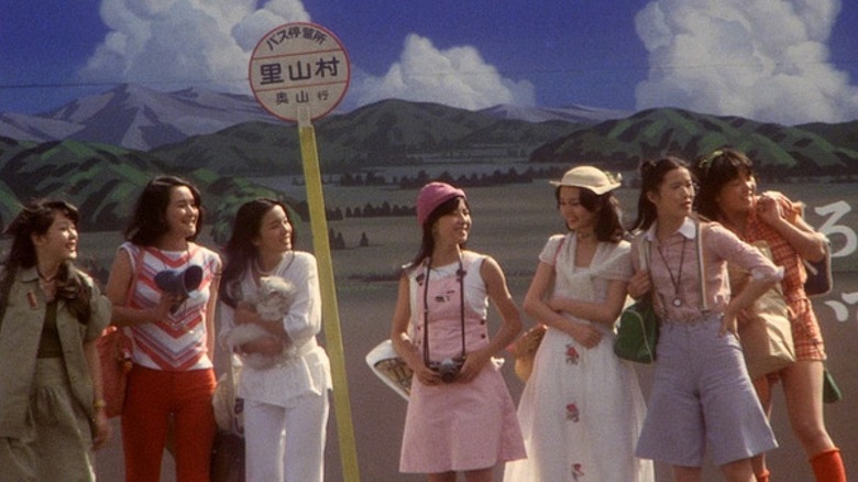 Girls smile at bus stop