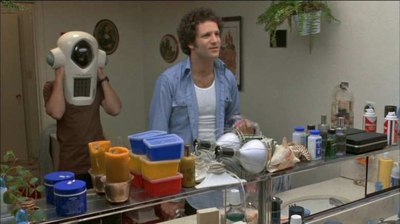 Albert Brooks looks in a mirror