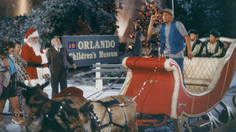 Ernest stands in Santa's sleigh