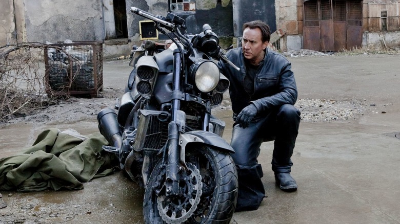 Johnny Blaze crouching by bike