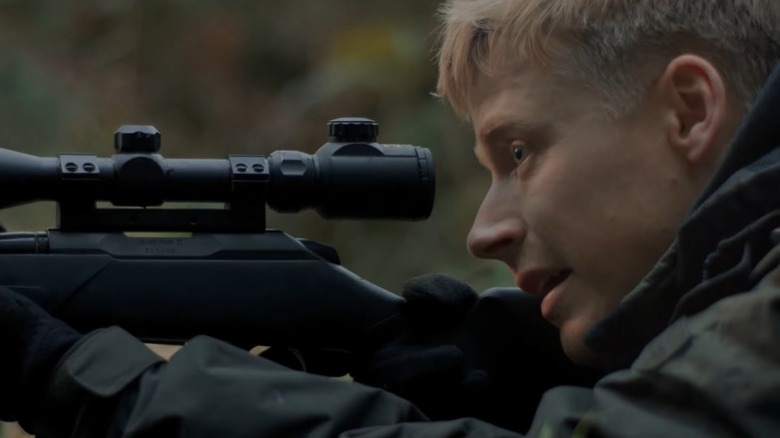 Jack Lowden holds gun