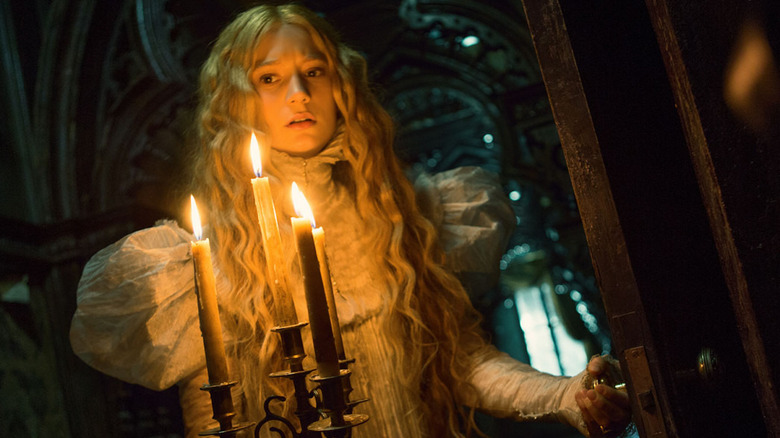 Mia Wasikowska holding candles