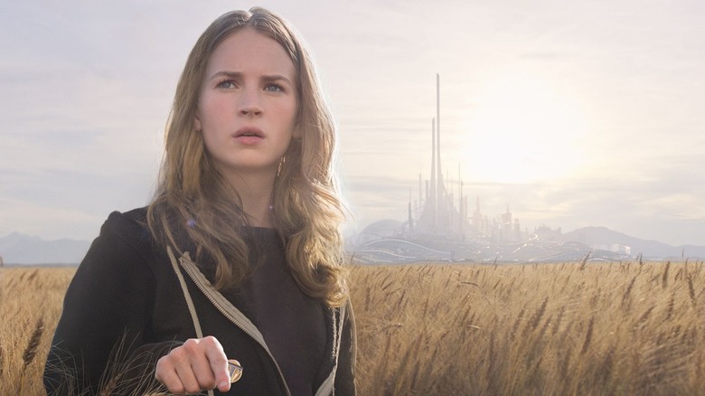 Casey stands in a field outside Tomorrowland