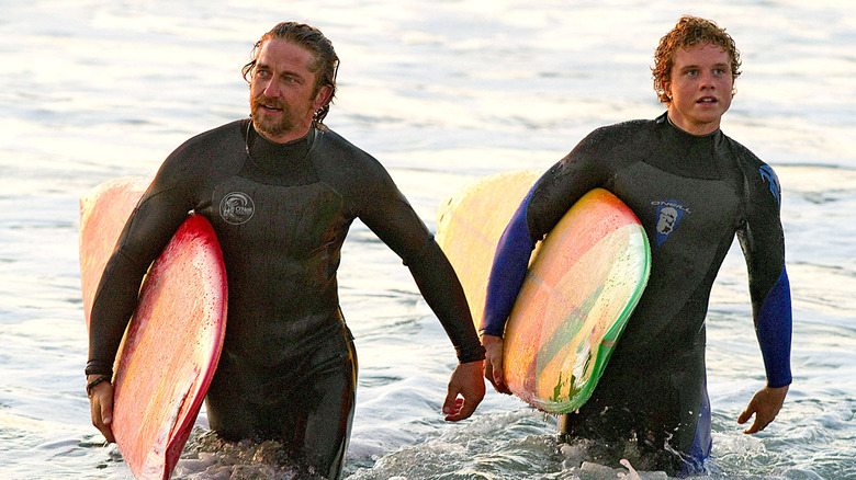 Gerard Butler and Jonny Weston walking in water