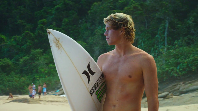 John Florence holding a surf board