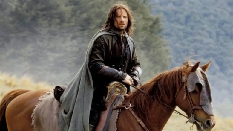 Aragorn riding a horse in Rohan