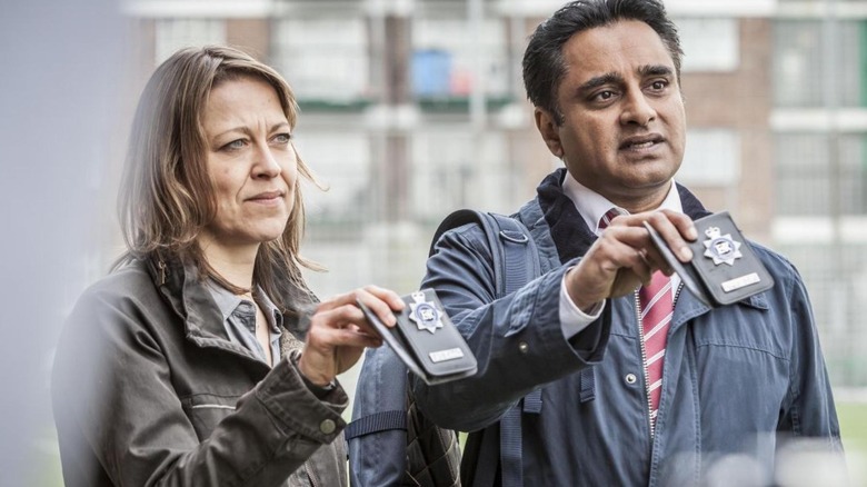 Cassie Stuart and Sunny Khan holding badges