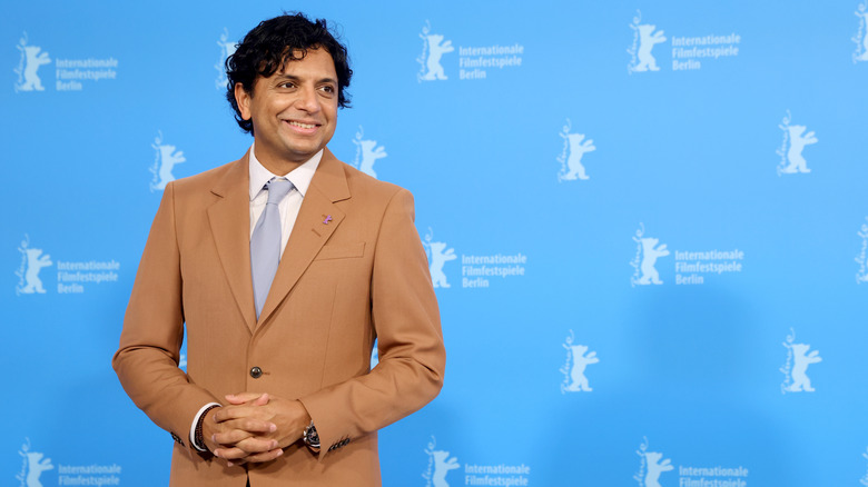 M. Night Shyamalan wearing tan suit