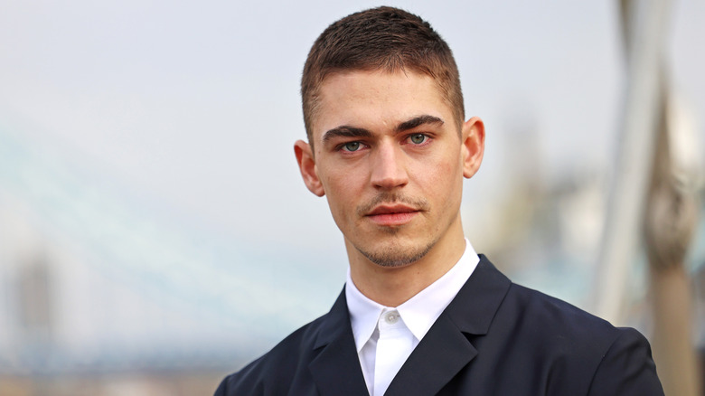 Hero Fiennes Tiffin posing in a smart, modern suit