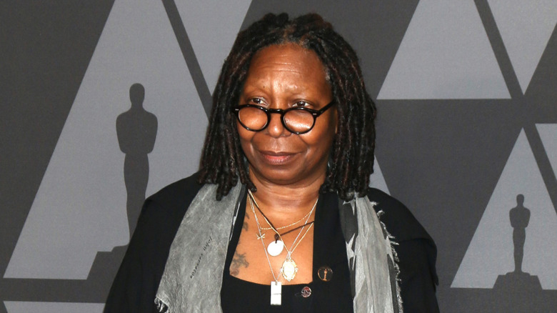 Whoopi Goldberg posing at a red carpet event.