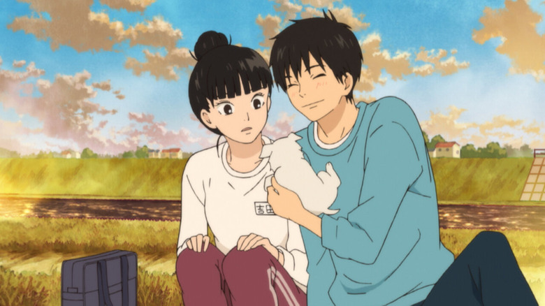 Sawako and Shōta playing with a dog