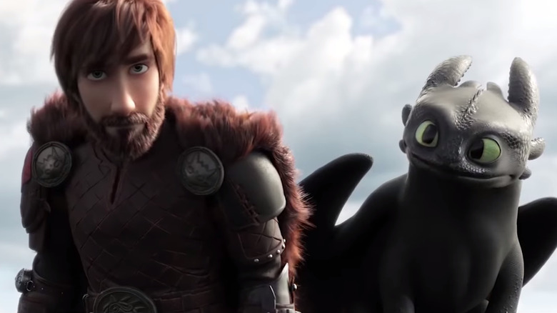 Hiccup standing with Toothless